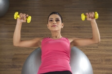 attractive female getting in shape on a fitness ball