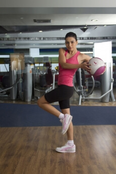 young girl doing her fitness workout with a small ball
