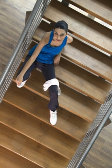 girl sitting on the stairs of a gym