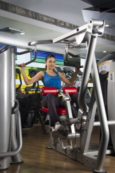 attractive woman at the gym working on a machine