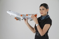 woman posing with an airplane
