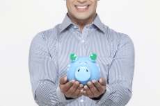 smiling man with piggy bank