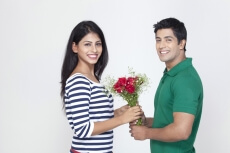 husband giving a bouquet to wife