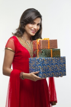 woman holding presents in a side pose