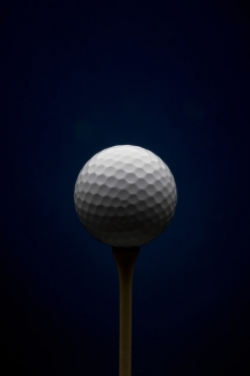 Golf ball with dark blue background