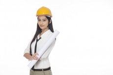 girl wearing hardhat and holding chart paper
