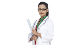 young confident doctor with stethoscope and cardboard in hand