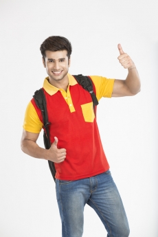 college boy smiling while showing thumbs up with both hands 