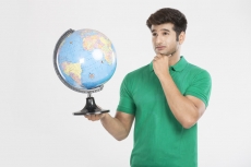 man posing with desktop globe 