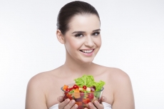 girl smiling and posing with salad