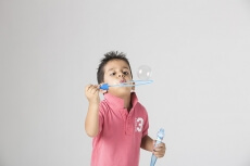 little boy playing with bubble toy