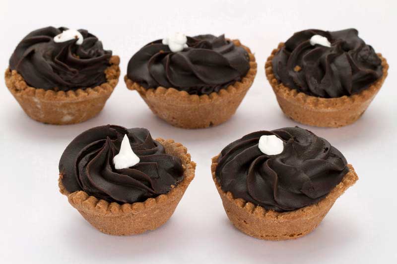 five cupcakes with vanilla topping