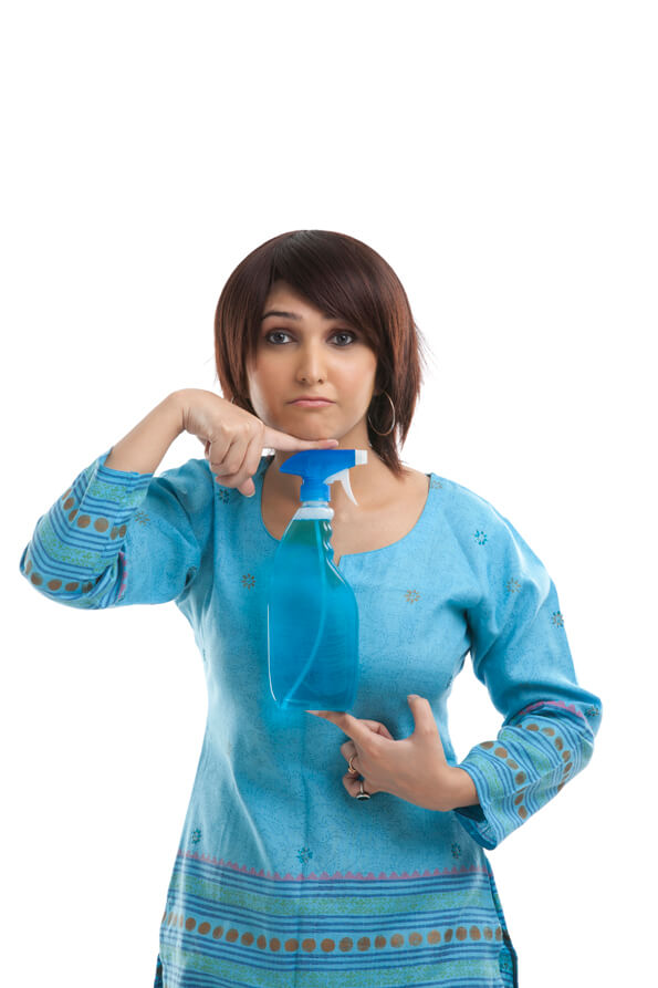 young woman leaning her face over a spray bottle