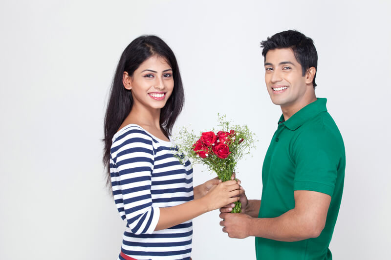 husband giving a bouquet to wife