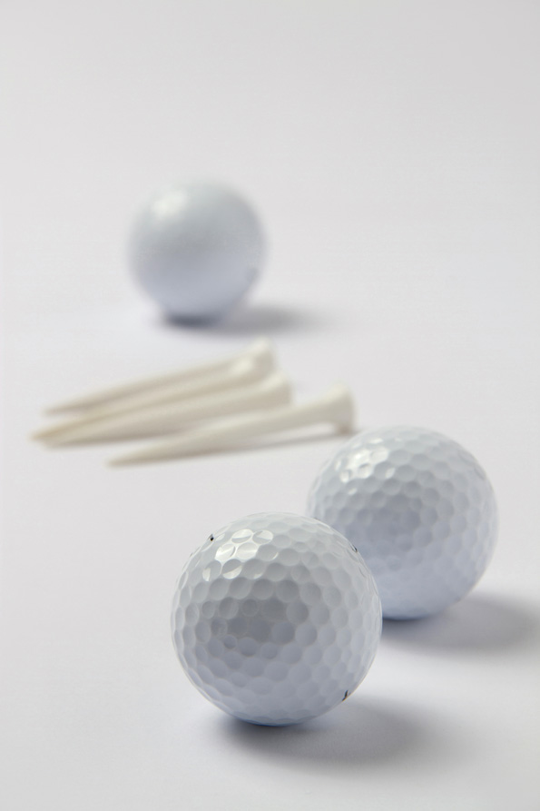 golf balls with white golf tees