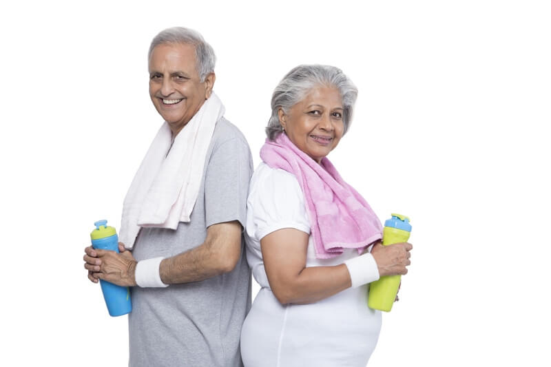 old couple in gym wear with bottle