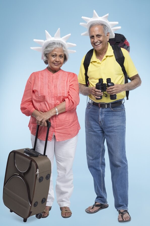 old couple travelling with their travelling bags 