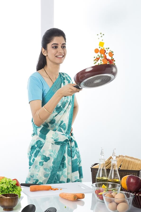 Indian housewife tossing up while cooking