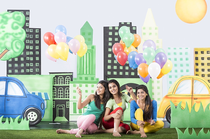 Three girls holding balloons